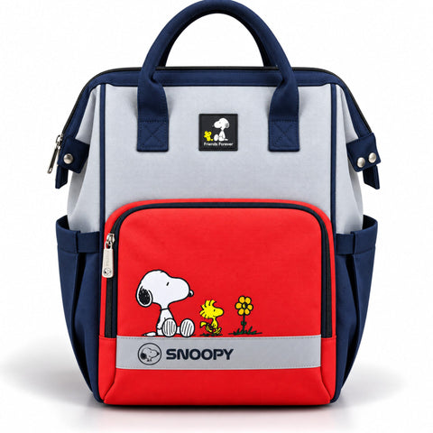 A navy blue and light gray diaper bag with a red front pocket featuring Snoopy and Woodstock illustrations, and a visible Snoopy patch on the front.