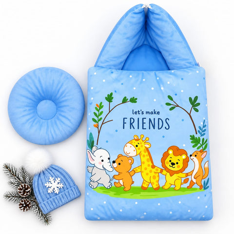 A blue baby sleeping bag set with a cartoon animal print reading 'let's make FRIENDS', shown with a matching blue donut pillow and a blue knit hat with a white pom-pom and snowflake, arranged on a white background with pine branches.