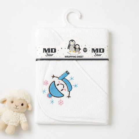 A white baby hooded towel wrapped in a branded MD Star wrapping sheet, hanging on a white hanger against a white background, with a small plush sheep toy beside it.